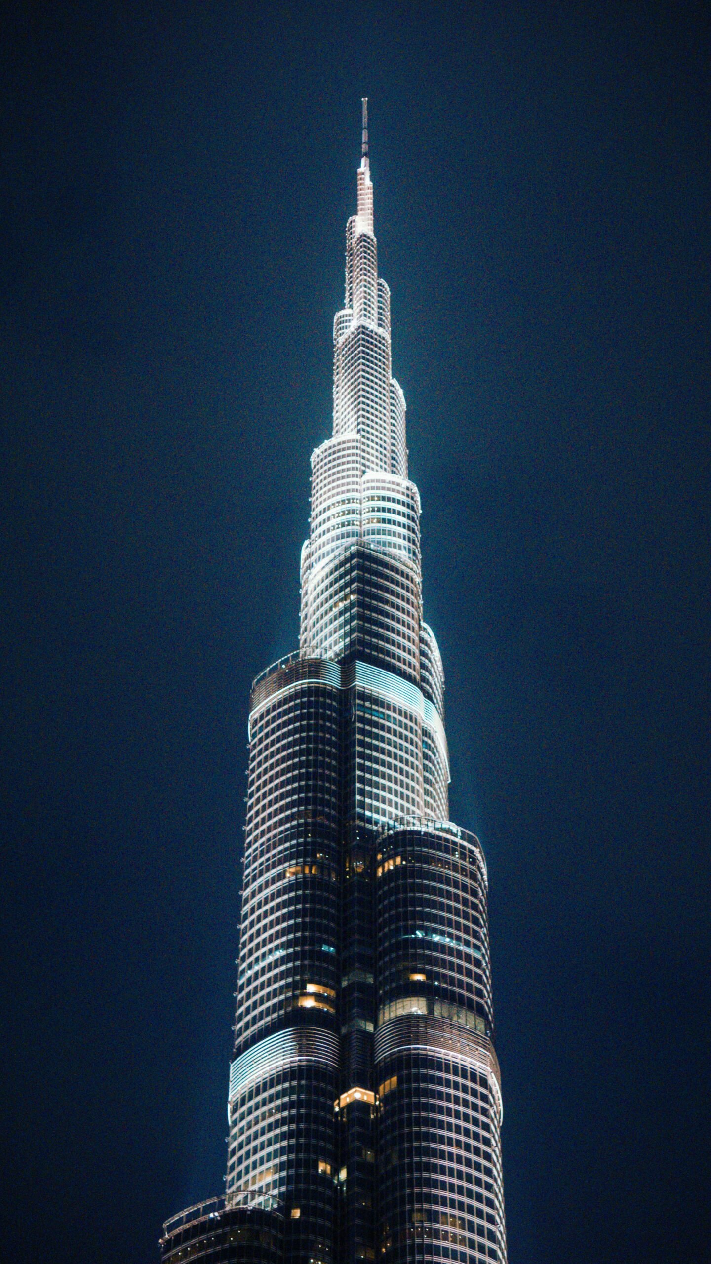 A breathtaking night view of the iconic Burj Khalifa, showcasing its architectural brilliance against a dark sky.